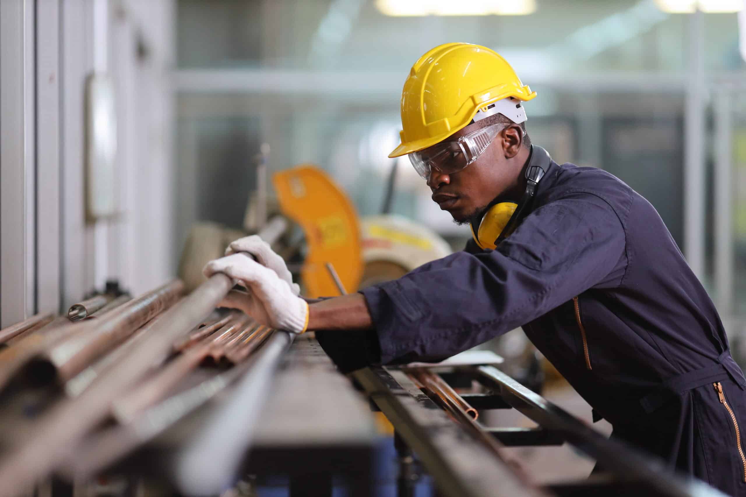 African American mechanic engineer worker is choosing copper tub African American mechanic engineer worker is choosing copper tub.