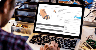 Empower Sales Team to Sell Person's hand on a laptop trackpad with a visible online store on the screen.
