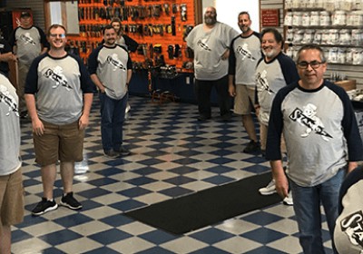 Stanion Wholesale Case Study Stanion Wholesale team inside a room with a checkered floor pattern.