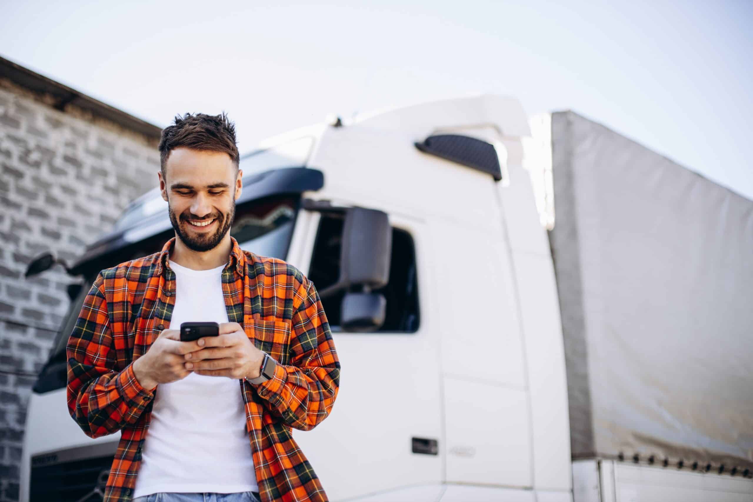 Truck driver smiling at phone