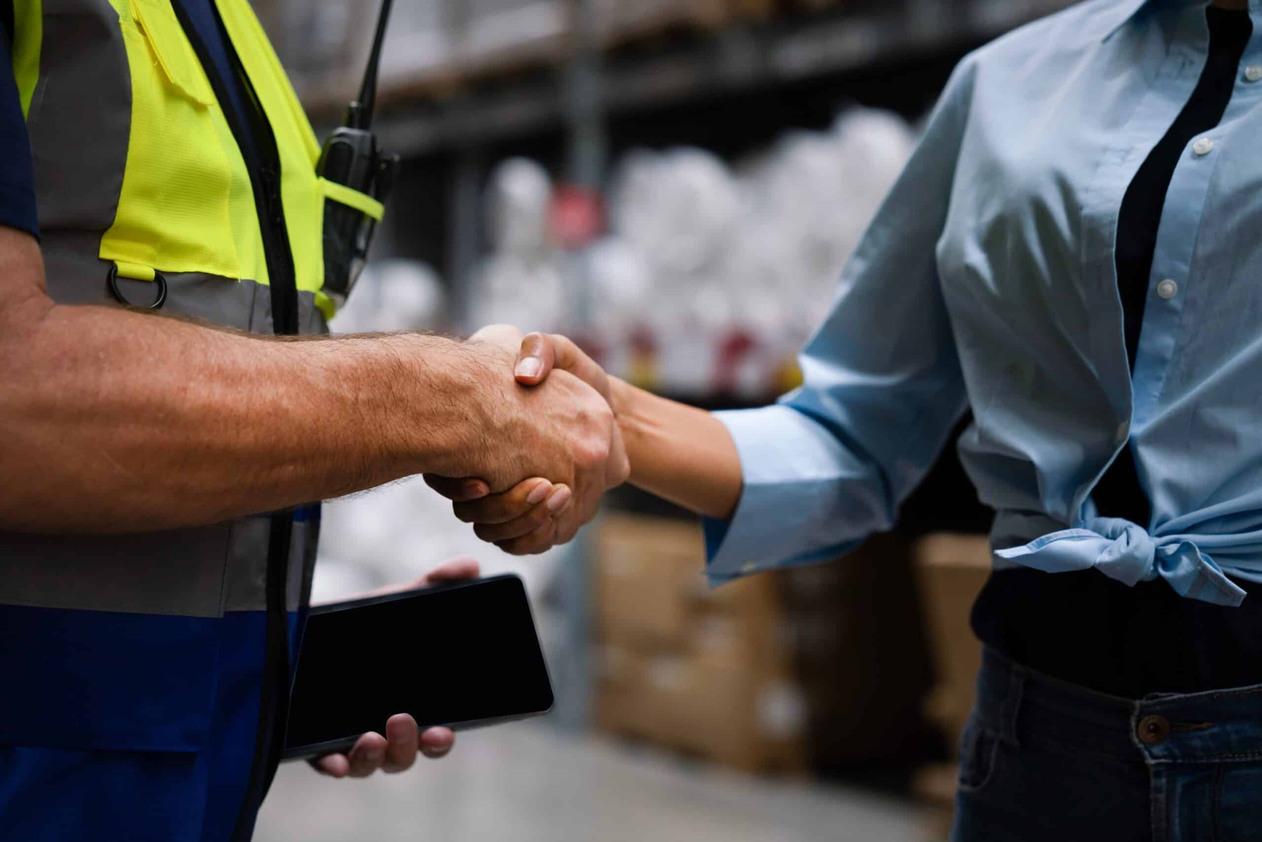 Manufacturer and distributor shaking hands