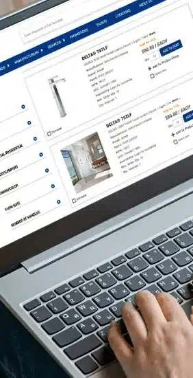 Laptop screen showing a CX1 Showroom product listing with faucet photos, specs, and pricing